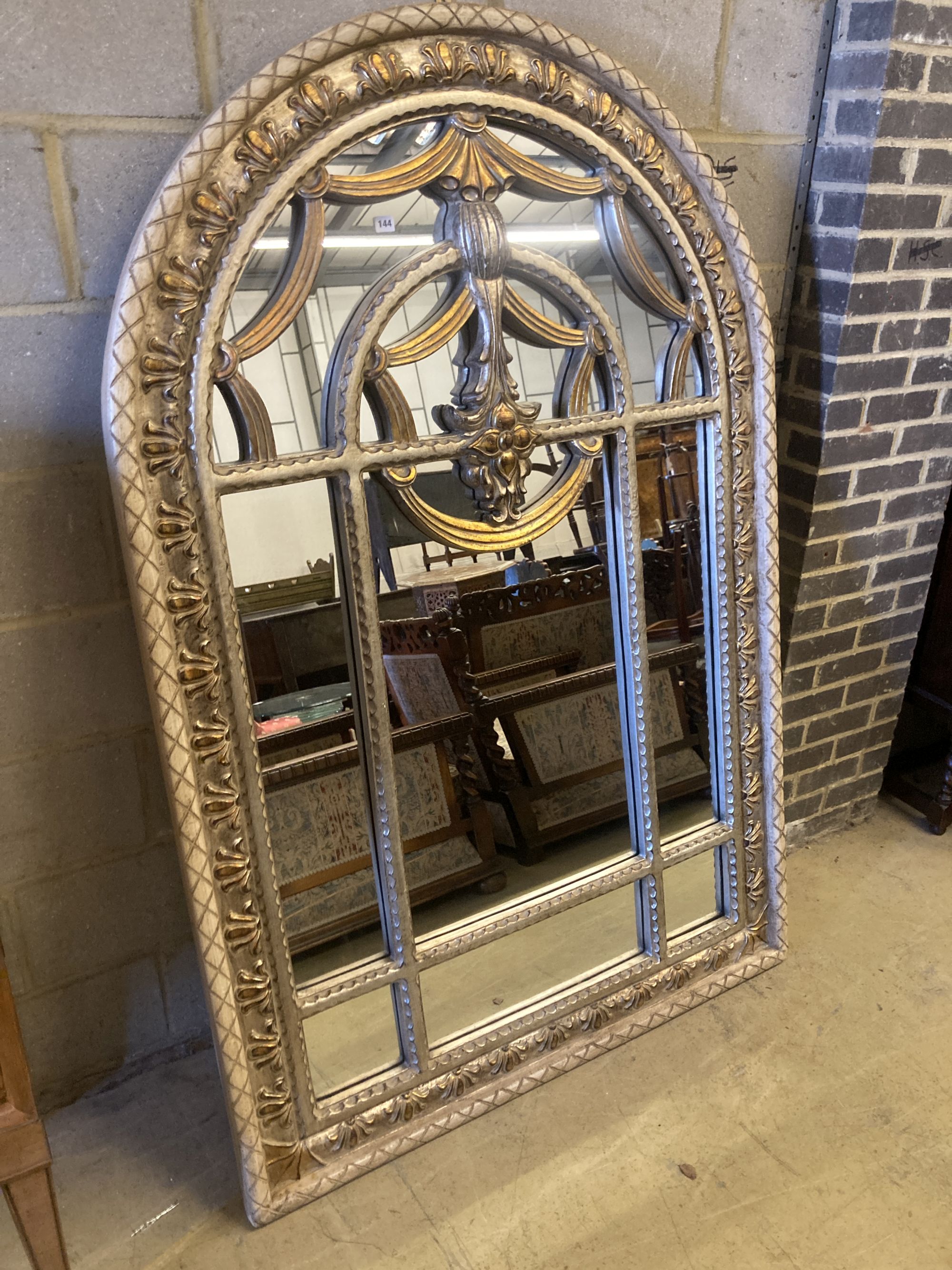 A reproduction parcel gilt arched top wall mirror, width 120cm, height 180cm
